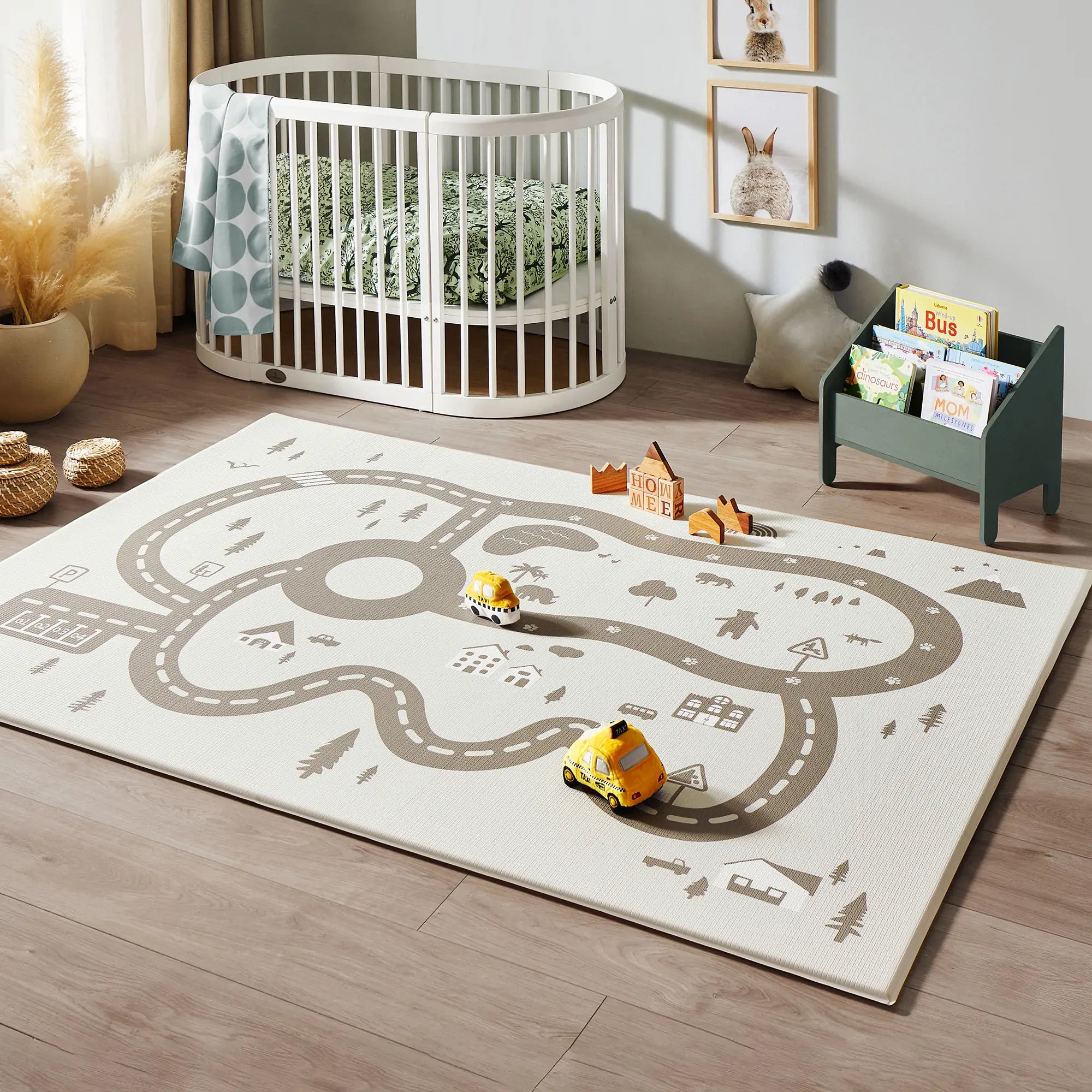 A well-arranged children's playroom with a train track play mat in the center.
