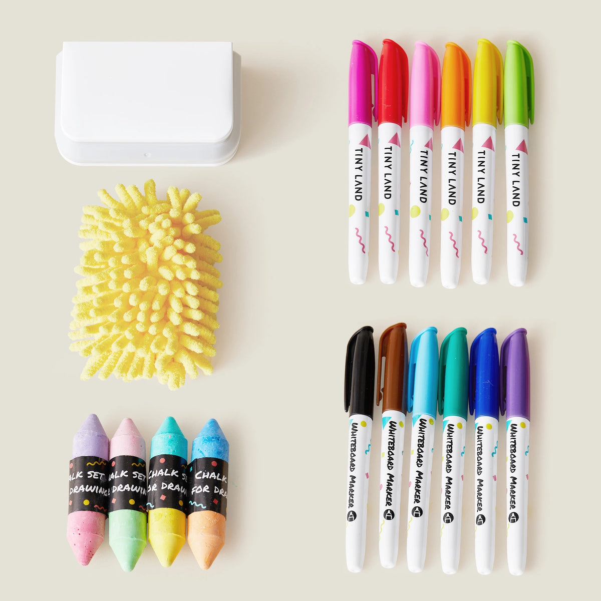 The Tiny Land® Magnitales Easel Art Kit by Tiny Land features four pastel chalks, a yellow textured sponge, a white eraser, six colored markers with pink caps, and six with multicolored caps—perfect as an easel accessory set.