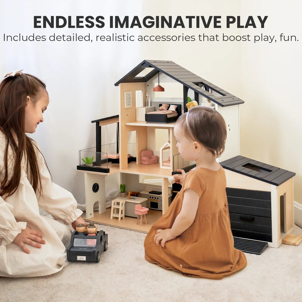 Two children in brown and beige dresses play with the Tiny Land Sweet Family Gift Set: Black Dollhouse & Dollhouse Garage & Extra Dolls, surrounded by detailed furniture and accessories that inspire endless imaginative play.