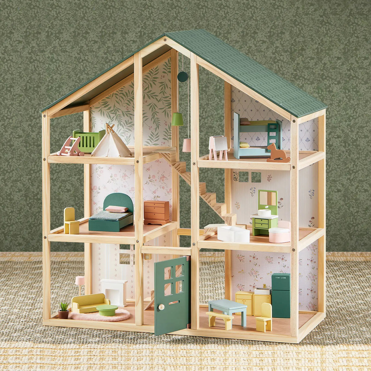 The Tiny Land® Sweetwood Evergreen Dollhouse by Tiny Land features six furnished rooms with an open front, miniature furniture and accessories, green patterned wallpaper, and a woven rug. Dolls are not included.|green