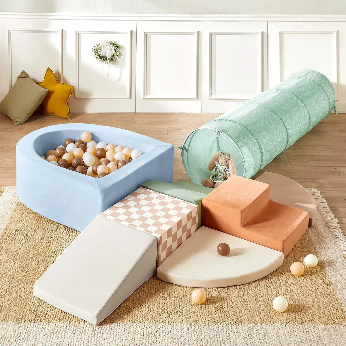 Transform your indoor playground with the Tiny Land® PlayNest Climbing Ball Pit Set with Tunnel. This soft play area features pastel foam shapes—including a slide, steps, tunnel, and a unique curved ball pit filled with beige, brown, and white balls—inviting little ones to explore under the trusted Tiny Land name. A cuddly stuffed bunny sits inside the tunnel while cozy cushions and a decorative wreath create an inviting background.|Blue
