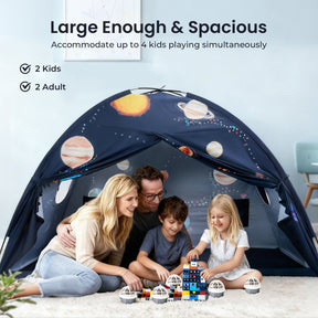 A smiling family—two adults and two kids—enjoys building with blocks inside the dark blue Tiny Land® Kids Bed Tent by Tiny Land, decorated with planets. Text highlights its spacious design for 4 kids or 2 adults and 2 kids.|SPACENEST