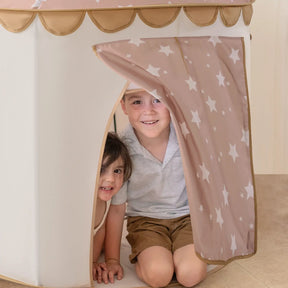 Two smiling children peek out from a Tiny Land® Kids Tent – Indoor Tent for Toddlers, featuring a pink star-patterned door flap and scalloped tan trim by Tiny Land.|Brown