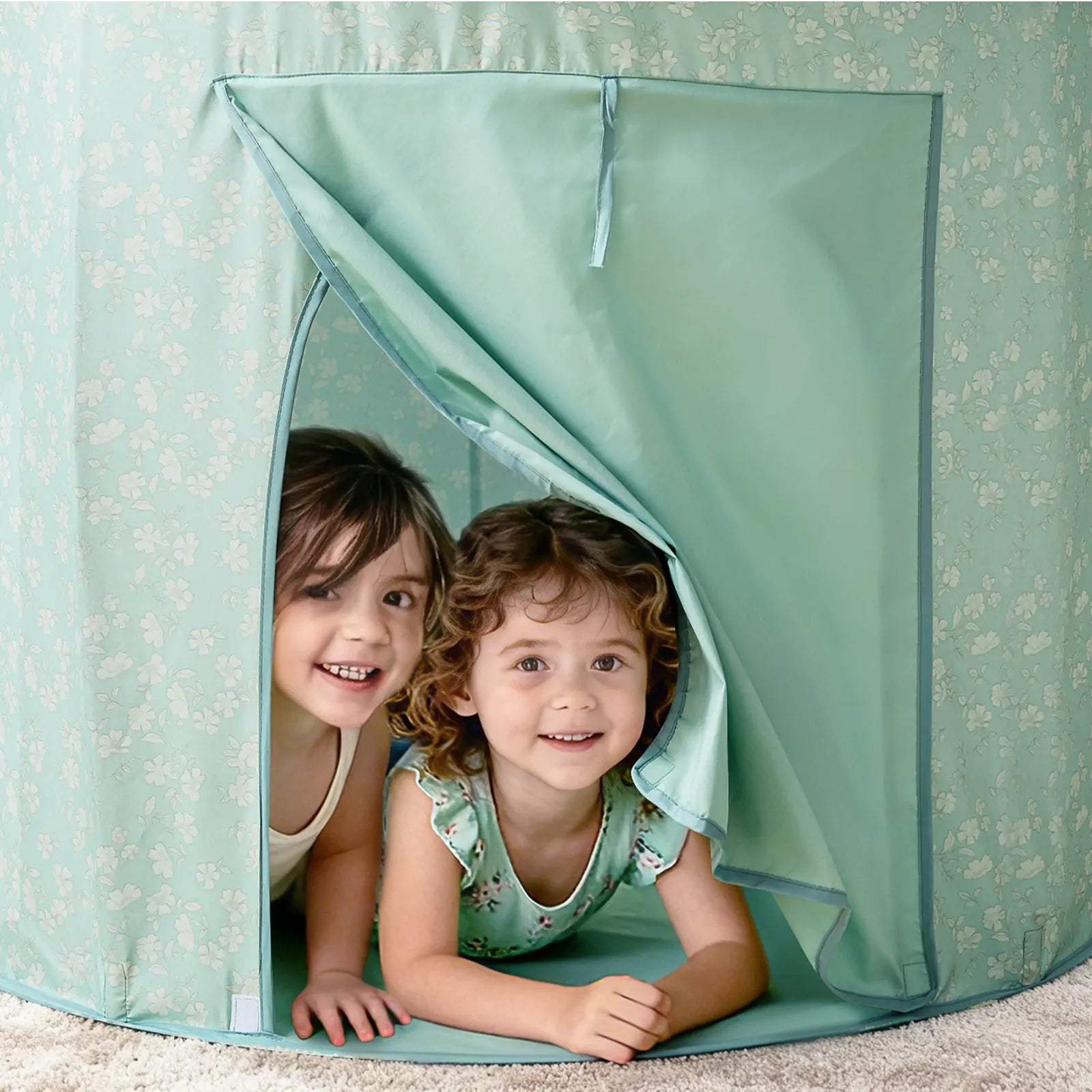 Two young children smile while playing in the Tiny Land® Green Adventure 3-in-1 Play Tunnel & Fun-Shapes Ocean Ball Set, enjoying the light green tunnel as sensory play sparks their imaginations and playful expressions.