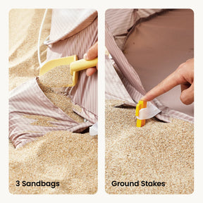 Close-up of the Tiny Land® 3-in-1 Baby Beach Tent: left shows sand filling one of 3 built-in sandbags, right shows a hand securing a yellow ground stake through a fabric loop in the sand. Labels: 3 Sandbags & Ground Stakes by Tiny Land.