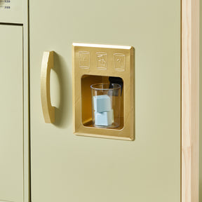 A plastic cup with blue toy ice cubes sits in a gold-colored pretend ice dispenser on the Tiny Land® PopJoy Play Kitchen - Green by Tiny Land.