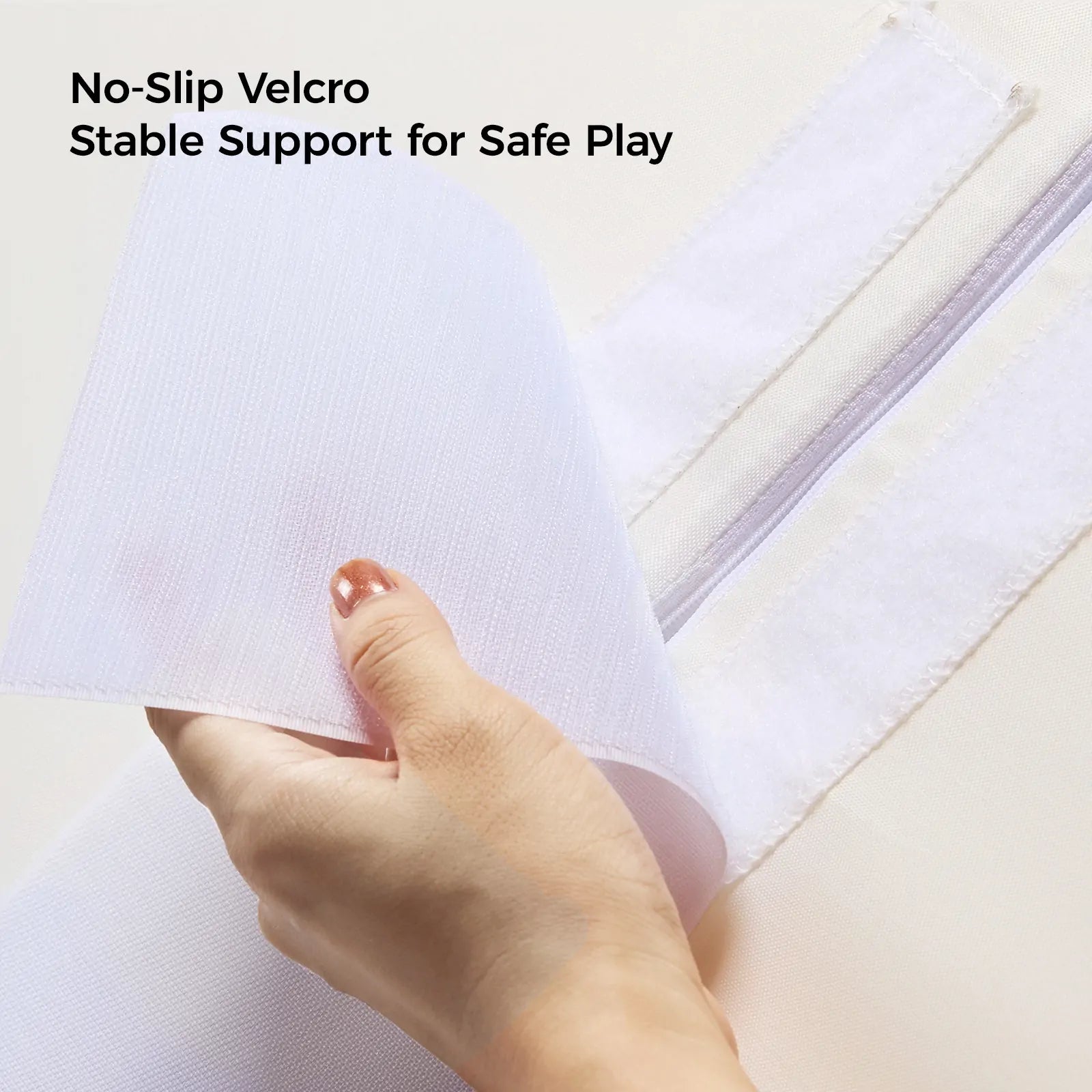 A hand peels back a strip of white Velcro on the Tiny Land® PlayNest Climbing Blocks, revealing a matching strip underneath. Text above reads: No-Slip Velcro. Stable support for safe play by Tiny Land. Ideal for gross motor development and climbing activities.