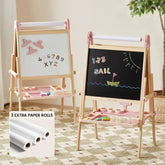 The Tiny Land® Pink Magnitales Easel & Paper Roll Set by Tiny Land features two wooden double-sided easels with pink accents, magnetic whiteboard and chalkboard ("1 2 3 SAIL" boat drawing), art supplies, a paper roll holder, and three extra rolls.|Pink