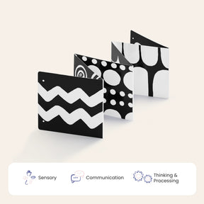 The Tiny Land® Montessori Toys for Newborns (0–3 Months) feature a black and white fold-out board with high-contrast patterns—perfect for sensory play during tummy time. Icons below highlight Sensory, Communication, and Thinking & Processing benefits.