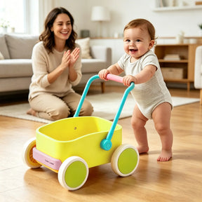 A smiling baby pushes the Tiny Land® 3-in-1 Wooden Baby Walker Wagon - Spring Color, featuring adjustable speed control, across the living room as a woman on the rug behind claps and smiles in encouragement.