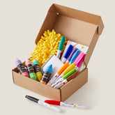 The Tiny Land® Magnitales Easel Art Kit by Tiny Land includes colorful markers, chalk-shaped crayons, a yellow fuzzy cloth, sticky notes, and extra markers—perfect for kids’ art projects or as whiteboard and chalkboard supplies.