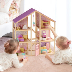 Two young children play with the Tiny Land® Sweetwood Unicorn Dollhouse, complete with pastel-colored rooms and Tiny Land wooden poseable dolls, on a pink rug in a bright bedroom.|Unicorn
