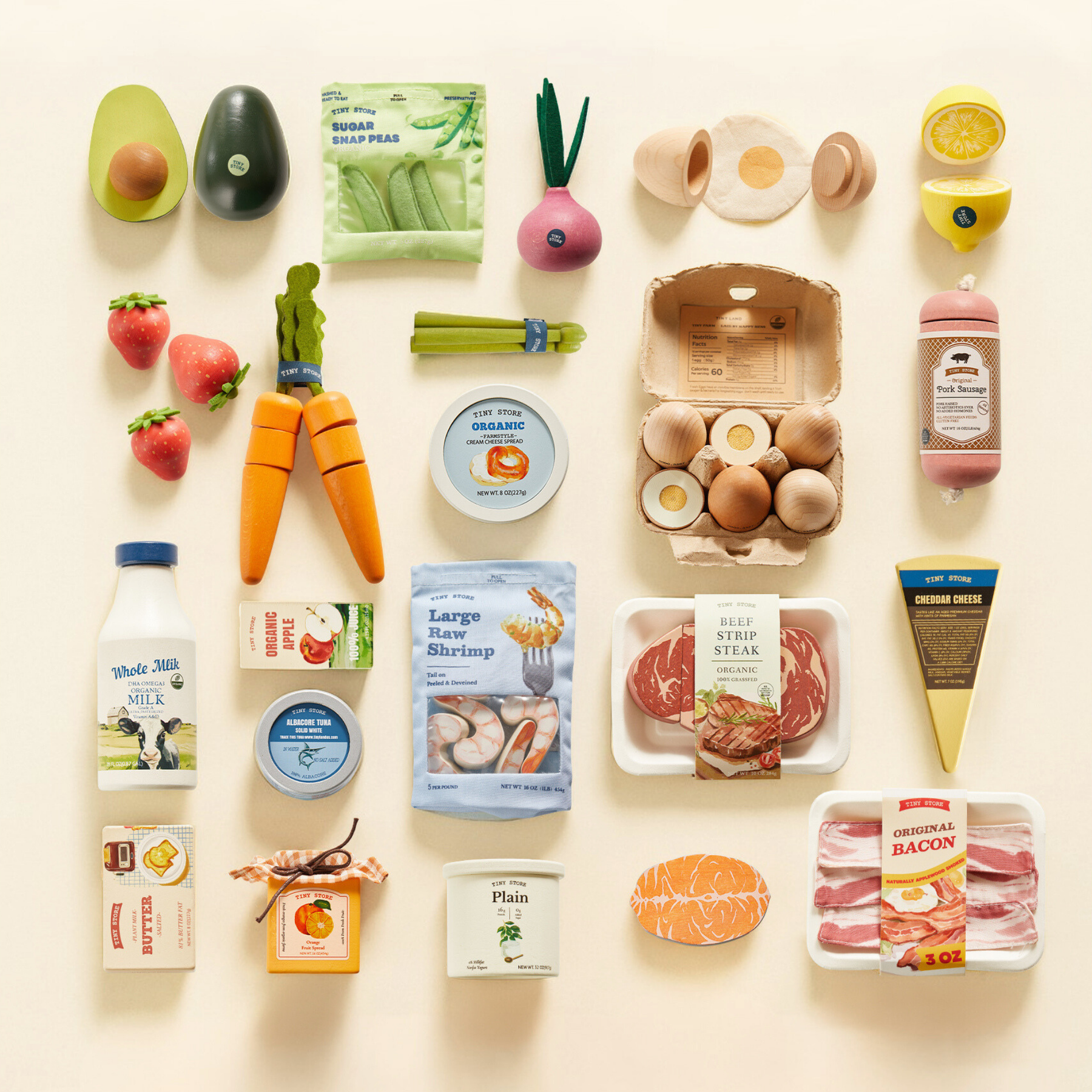 The Tiny Land® Organic Play Food Set by Target features a tidy grid of pretend eggs, milk, cheese, shrimp, steak, veggies, fruits, and condiments on a light background.