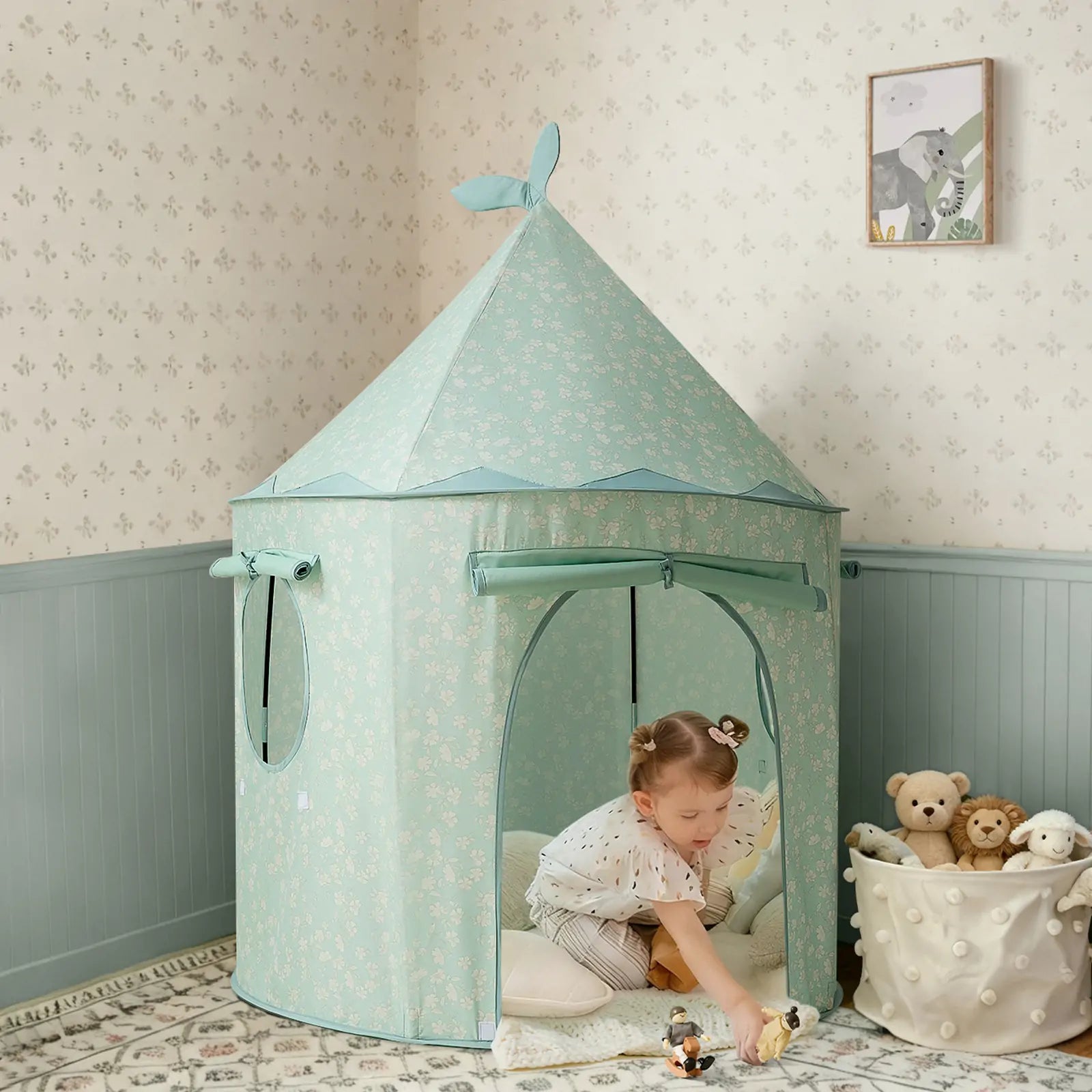 A young child plays with Tiny Land® Tiny Sprout Castle Tent, decorated with white floral patterns, in a cozy room. Plush toys and framed animal art appear in the softly lit background.|Green