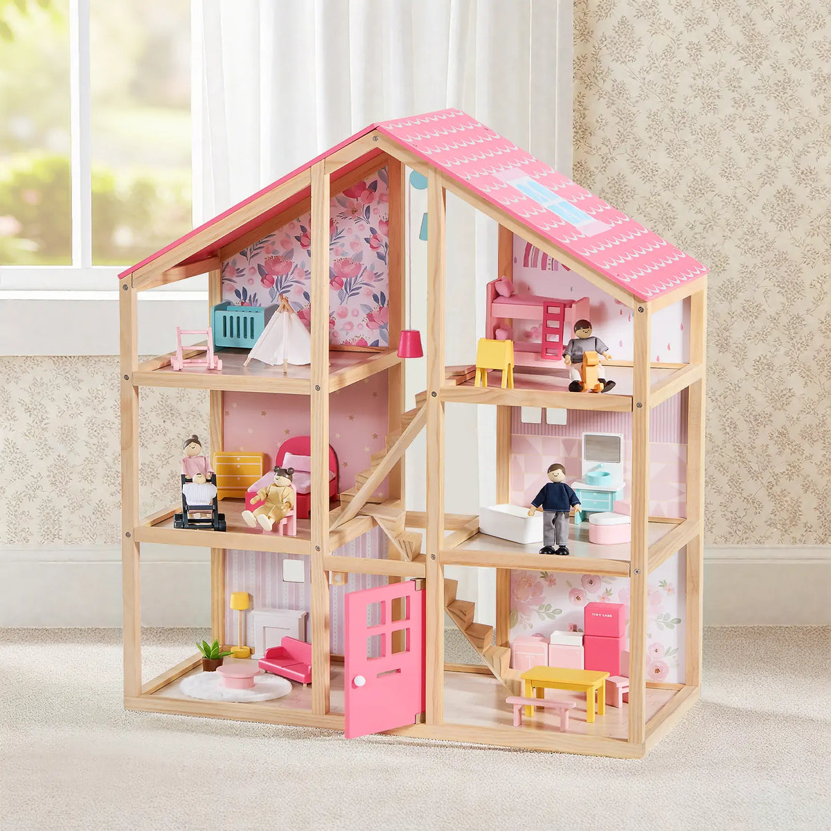 The Tiny Land® Sweetwood Love Dollhouse features a pink roof, decorated rooms, charming dollhouse furniture, and a wooden doll family set. From Tiny Land, it’s perfect for imaginative play in a beautifully detailed setting.