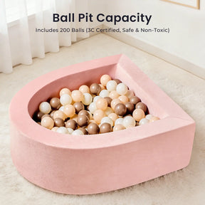 The Tiny Land® PlayNest Climbing & Ball Pit Set by Tiny Land is a pink, semi-circular foam ball pit filled with beige, brown, and white balls. The text above reads: "Ball Pit Capacity - Includes 200 Balls (3C Certified, Safe & Non-Toxic)." Perfect for a soft indoor playground setting, the ball pit rests on a light-colored floor.|Pink