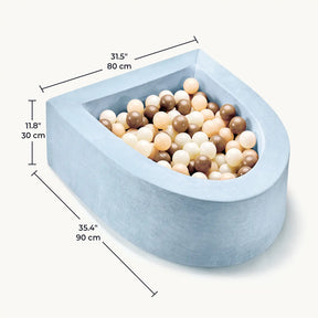 The Tiny Land® PlayNest Ball Pit with 200 ocean balls by Tiny Land features a light blue, soft-sided rectangular foam design filled with beige, brown, and white ocean balls. Measuring 35.4 x 31.5 x 11.8 inches (90 x 80 x 30 cm), it creates a cozy play space for toddlers.|Blue