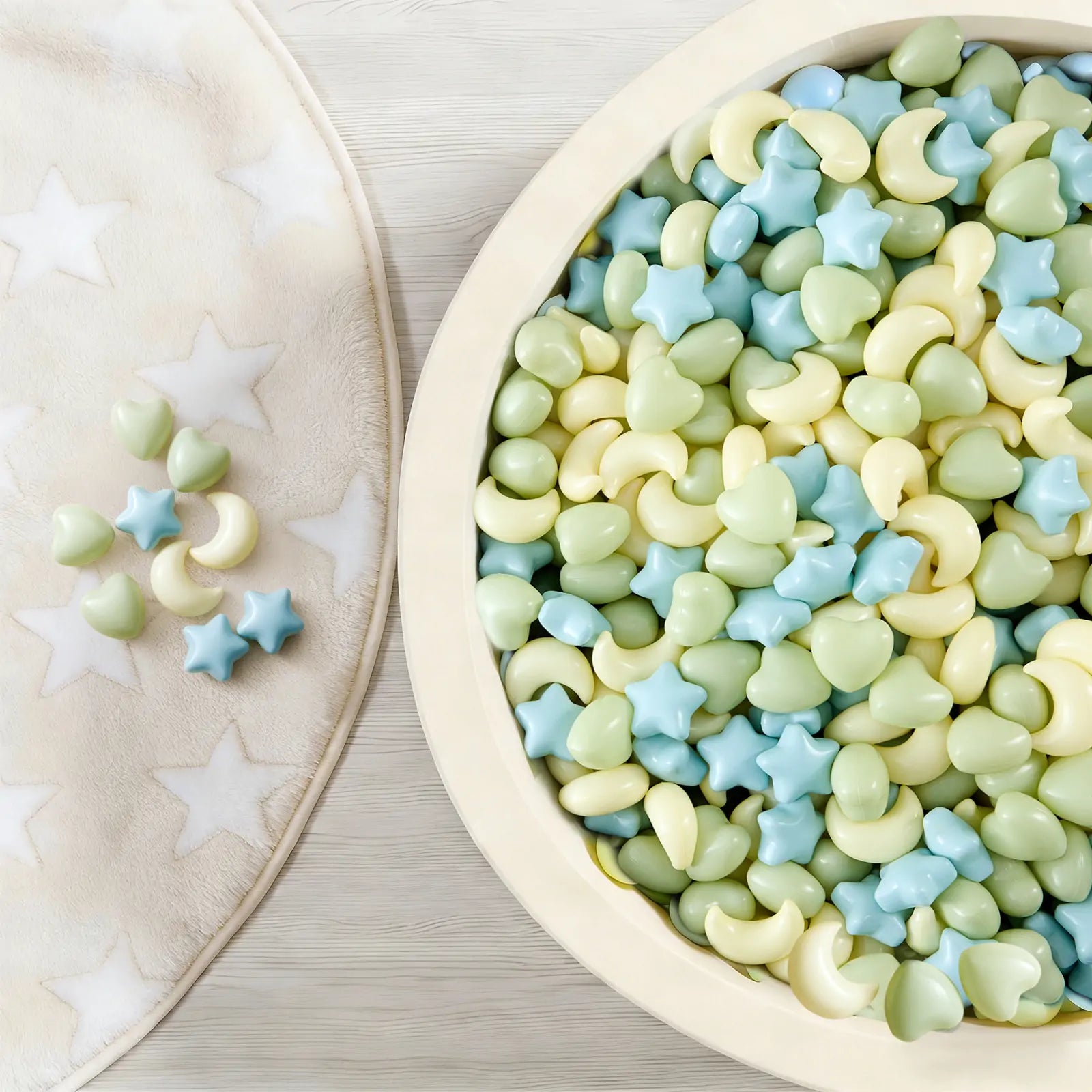 The Tiny Land® Green Adventure 3-in-1 Play Tunnel & Fun-Shapes Ocean Ball Set by Tiny Land features ocean balls shaped like stars, hearts, and crescent moons in blue, green, and yellow—perfect for sensory play and little hands to explore.