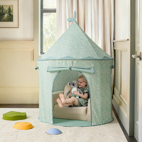 A young child sits inside the Tiny Land® Tiny Sprout Castle Tent, a pastel blue playhouse with floral patterns, holding a stuffed elephant. The tent by Tiny Land is set up on soft mats in a cozy, well-lit room.|Green