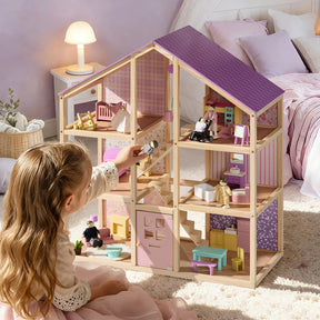 A young girl in a pink dress enjoys her Tiny Land® Sweetwood Unicorn Dollhouse, with a purple roof and pastel rooms, playing with poseable Wooden Dollhouse Dolls. Cozy bedroom lighting highlights the Tiny Land brand’s magical set.|Unicorn