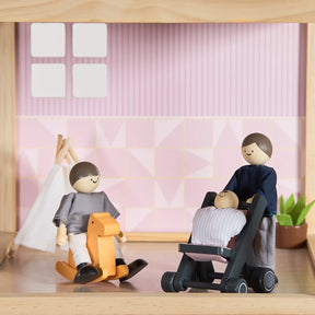 A Tiny Land® Sweetwood Love Dollhouse & Wooden Dollhouse Dolls set features a wooden doll family with a stroller, baby, and rocking horse, plus dollhouse furniture in rooms with pink and white walls, window, teepee, and plant.