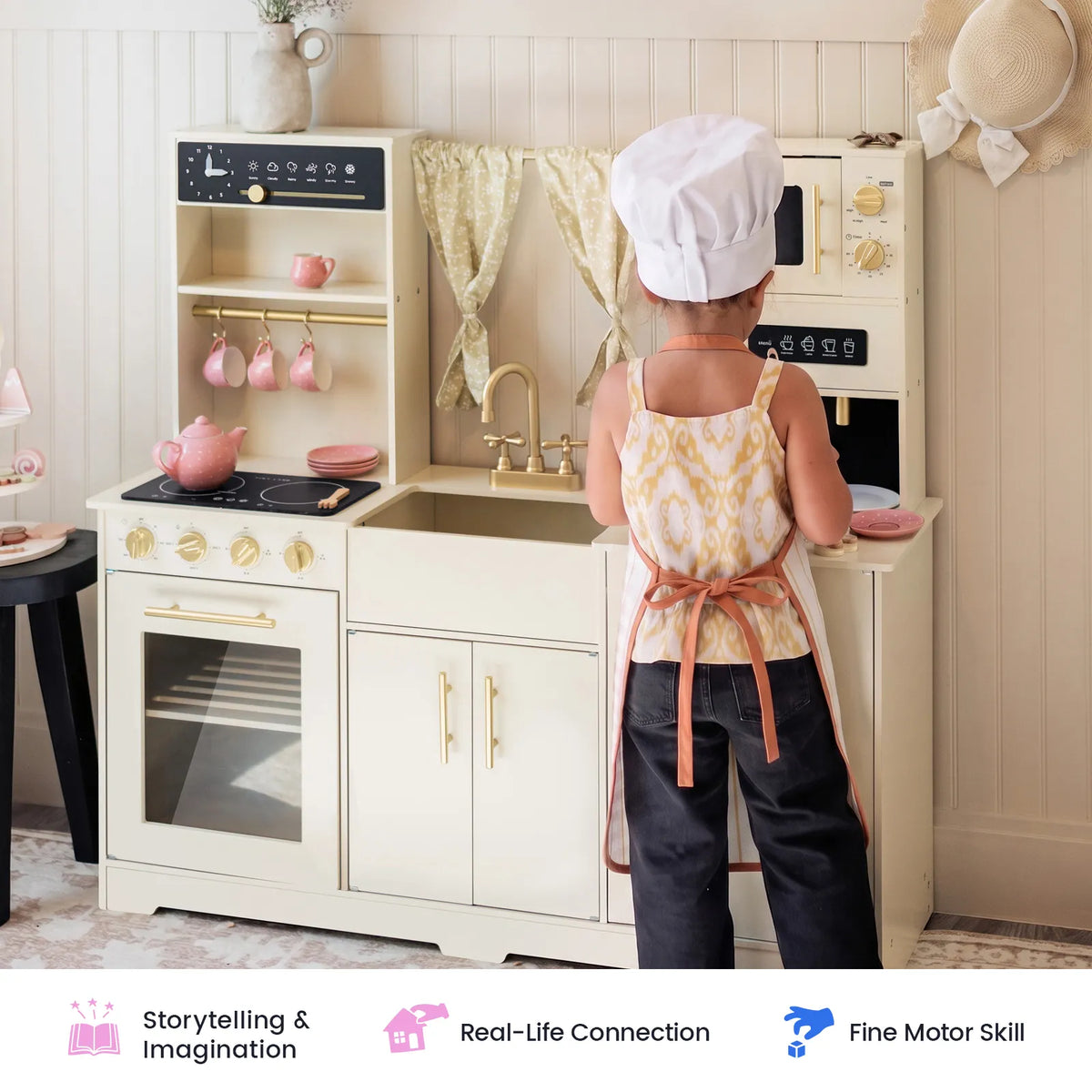 A child wearing a chef hat and apron enjoys imaginative play with the Tiny Land® Iconic Wooden Play Kitchen – Cream Pretend Cooking Set for Kids, pretending to cook just like a real chef. Icons below showcase benefits such as encouraging storytelling, fostering real-life connections, and enhancing fine motor skills—making this Tiny Land kitchen perfect for hours of creative pretend play.