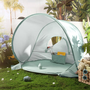 The Tiny Land® One-Stop Beach Toy & Tent Set in Sea Blue offers UV protection and a cozy interior, perfect for outdoor retreats. Surrounded by plants and flowers, it creates a sunny space for relaxation on the grass.|Sea Blue