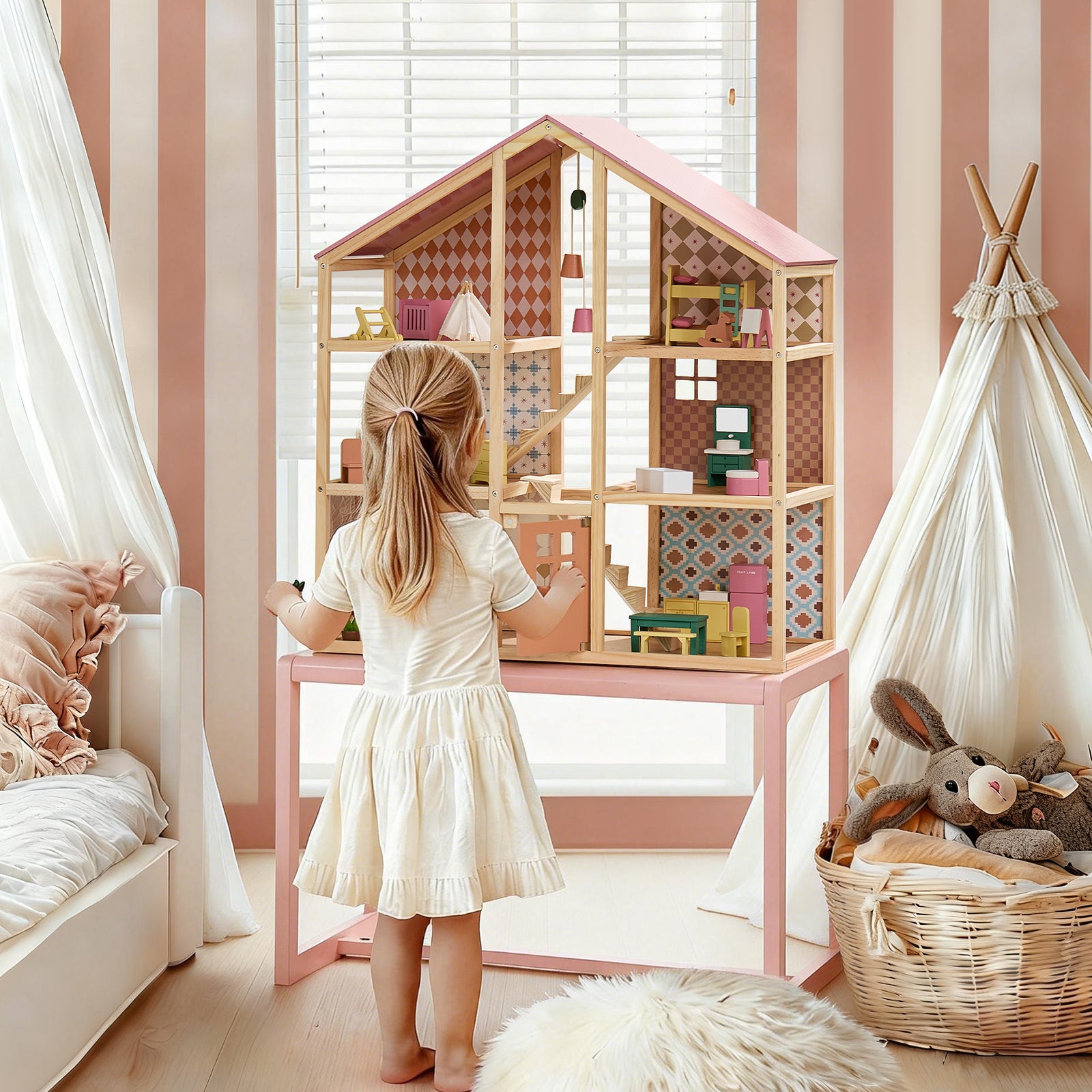 A young girl in a white dress enjoys imaginative play with her Tiny Land® Sweetwood Dollhouse without Dolls by Tiny Land in a softly decorated bedroom with striped wallpaper, a bed, and a basket of plush toys.|Pegasus