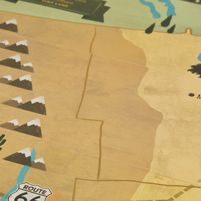 A close-up of the Tiny Land® 1920 Railway Adventure Train Table by Tiny Land shows a vintage-style map with Route 66, stylized scenery in muted tones, and an interactive wooden train set winding past a Route 66 road sign.