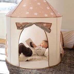 A young child relaxes on a pillow inside the Tiny Land® Compact Adventure 3-in-1 Play Tunnel, reading a book as sunlight streams through a nearby window. The star-patterned tent, from Tiny Land, along with the adjoining tunnel and ball pit (balls not included), creates a cozy and inviting space that sparks imaginative play.|brown