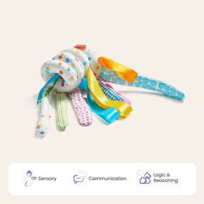 Tiny Land® Montessori Toys for Newborns (0–3 Months) by Tiny Land feature soft, colorful fabric loops and ribbons to promote sensory play, communication, and logic & reasoning skills. Icons for these skills appear below the toy.