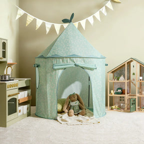 A children’s playroom featuring the Tiny Land® Tiny Sprout Castle Tent in mint-green with a plush bunny inside, a toy kitchen to the left, a dollhouse to the right, and a bunting banner on a cream-colored wall.|Green