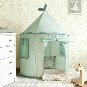 The Tiny Land® Tiny Sprout Castle Tent in mint green, featuring a pointed roof and leaf accents, stands in a child’s room with floral wallpaper, near a wooden rocking horse, white dresser, and framed goose picture on the wall.|Green
