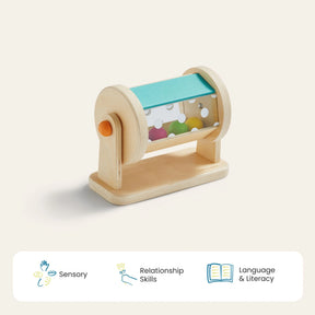 The Tiny Land® Montessori Toys for Newborns (4–6 Months) by Tiny Land features a wooden rotating drum with colorful beads to build fine motor skills, with icons showing benefits: Sensory, Relationship Skills, and Language & Literacy.