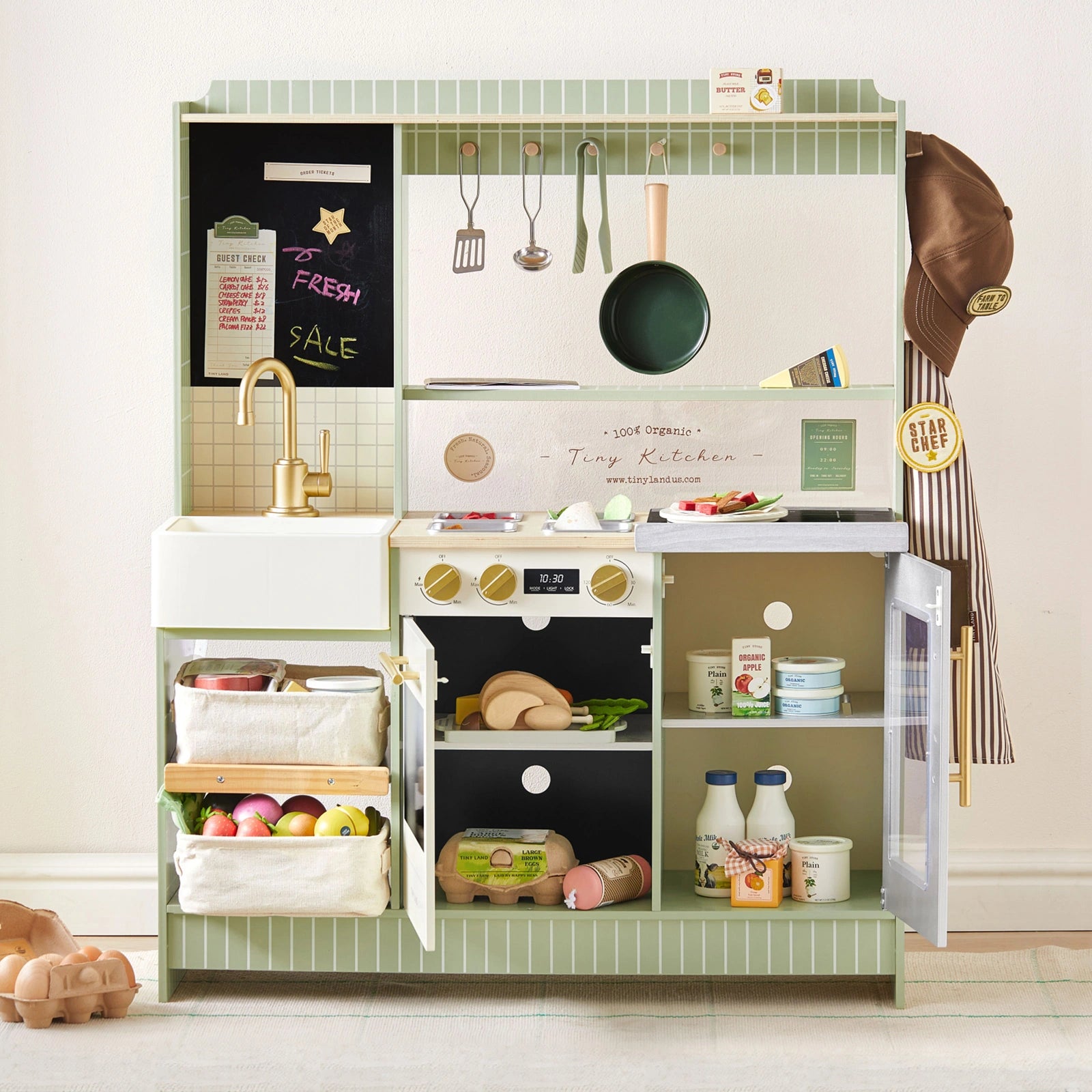 The Tiny Land® BistroSwitch Play Kitchen by Tiny Land includes green tiles, gold faucet, stove, utensils, play food, grocery baskets, chalkboard, chef’s hat, apron & a stocked fridge—perfect for imaginative kids’ kitchen adventures.|Green