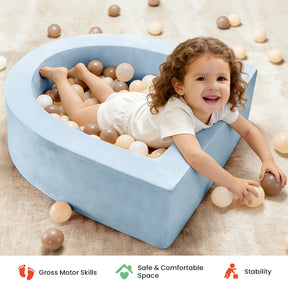 A smiling child in a white outfit lounges in the Tiny Land® PlayNest Ball Pit with 200 Ocean Balls by Tiny Land, surrounded by soft blue foam walls and ocean balls in white, beige, and brown. Icons below highlight benefits such as developing gross motor skills, creating a safe toddler play space, and providing stability.|Blue