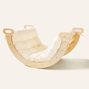 A Tiny Land® Thick Padded Play Cushion with cream-colored tufting is featured, paired with a modern crescent-shaped wooden rocking chair (arch not included) by Tiny Land, set against a plain light background.