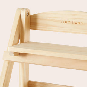 Close-up of the Tiny Land® Play Kitchen Accessories wooden rack with two tiers and TINY LAND engraved on top. Made from eco-friendly wood, this minimalist storage shelf keeps play food organized in any kids room.