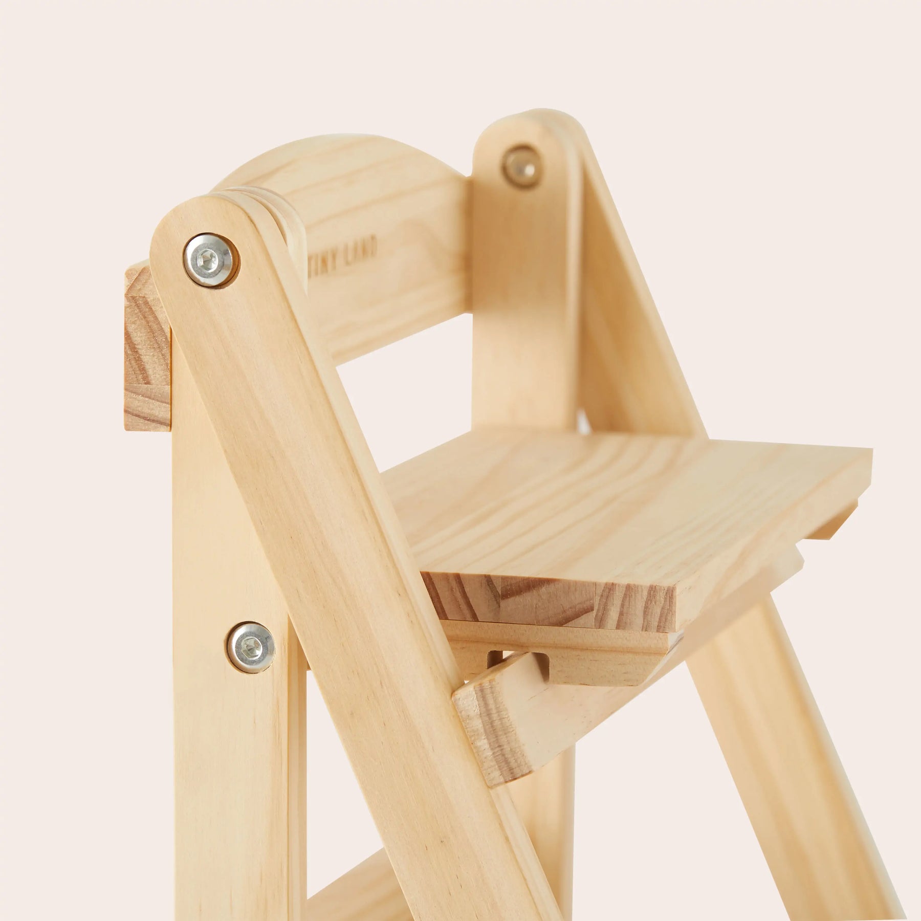 A close-up of the Tiny Land® Play Kitchen Accessories Wooden Rack shows its eco-friendly wood, visible screws, and natural grain, photographed against a plain, light background. Ideal for versatile play kitchen food storage from Tiny Land.