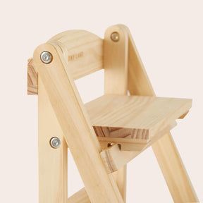 A close-up of the Tiny Land® Play Kitchen Accessories Wooden Rack shows its eco-friendly wood, visible screws, and natural grain, photographed against a plain, light background. Ideal for versatile play kitchen food storage from Tiny Land.
