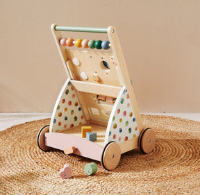 The Tiny Land® Versatile Natural Wooden Baby Walker by Tiny Land features colorful beads, polka dot sides, and a tray of geometric blocks, displayed on a woven round rug against a neutral background|Morandi