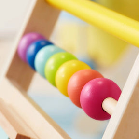 Close-up of the Tiny Land All-Rounder Baby Playset—a baby walker with a rainbow abacus featuring six large, colorful beads in a sturdy wooden frame, ideal for Montessori play for ages 7-9 months|Rainbow