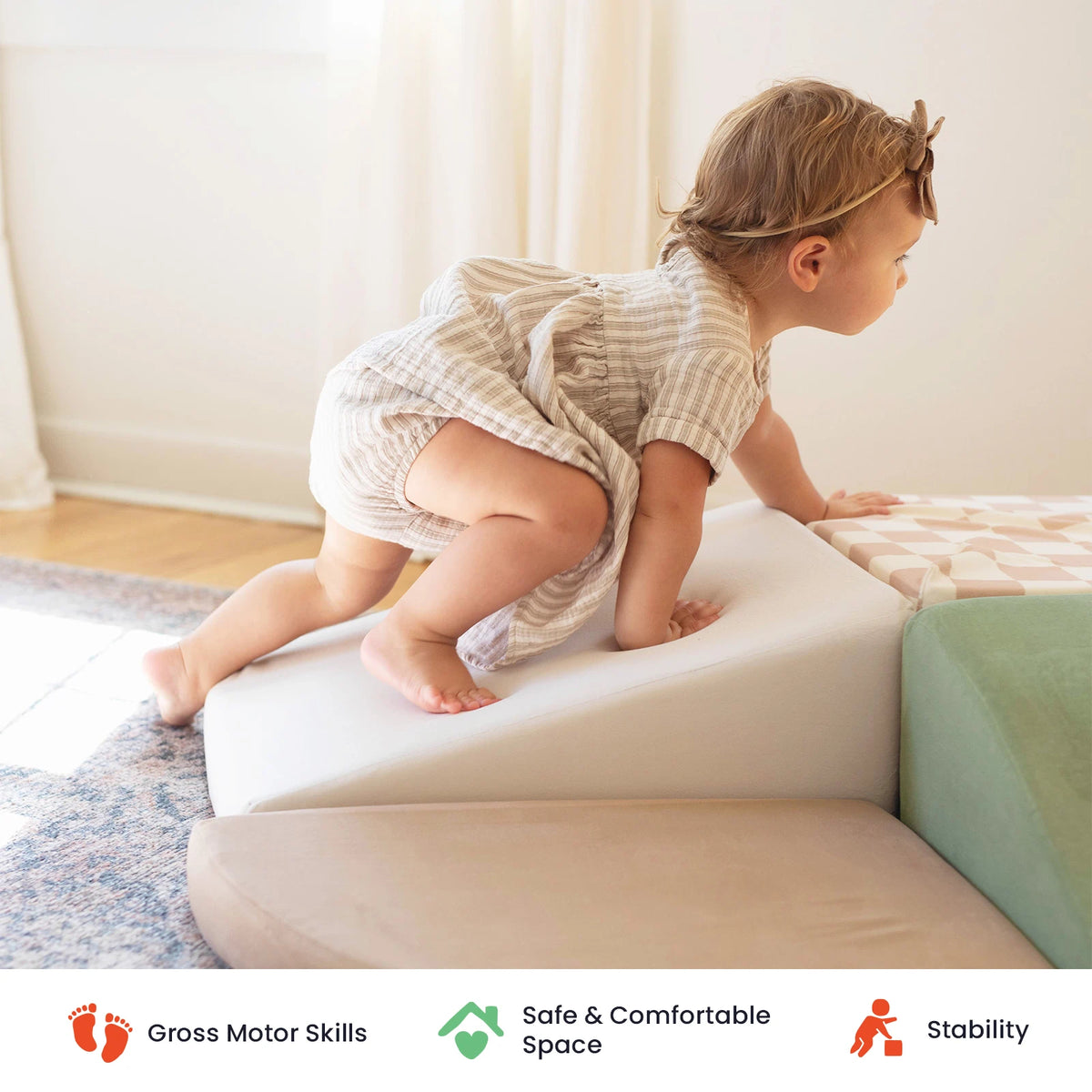 A toddler climbs a soft foam ramp in a bright room, part of the engaging Tiny Land® PlayNest Climbing Blocks by Tiny Land. Icons below highlight key benefits: gross motor skill development, sensory exploration, a safe and comfortable environment, and enhanced stability.