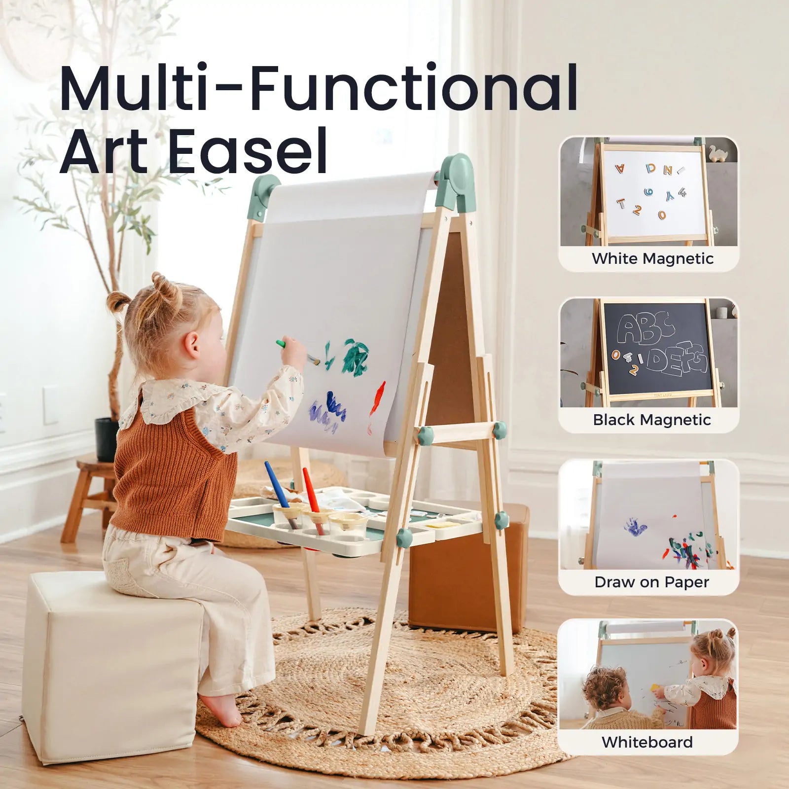 A young child paints on the Tiny Land Nature-inspired Play & Art Set — Sage Easel + Forest Play House. Inset images show four easel uses: white magnetic, black magnetic, paper drawing, and whiteboard. Art supplies inspire creativity nearby.|green