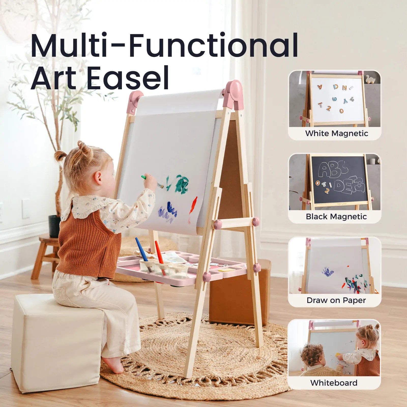 A young child sits on a cushioned stool, drawing with paint on the Tiny Land® Magnitales Easel for Kids - Pink. This multi-functional easel by Tiny Land features white and black magnetic boards, paper drawing, whiteboard options, and holds art supplies on its tray.|pink