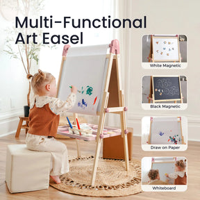 A young child sits on a cushioned stool, drawing with paint on the Tiny Land® Magnitales Easel for Kids - Pink. This multi-functional easel by Tiny Land features white and black magnetic boards, paper drawing, whiteboard options, and holds art supplies on its tray.|pink