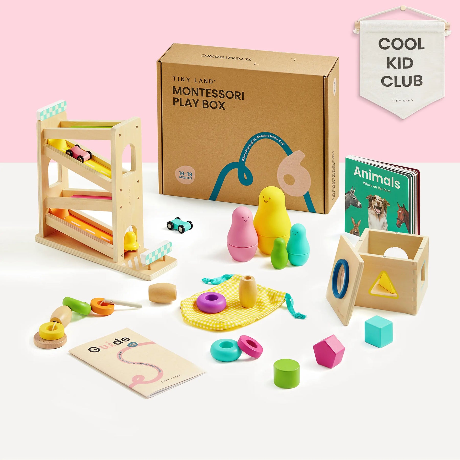 The Tiny Land® Mystery Surprise Box by Tiny Land includes premium Montessori toys: wooden stacking figures, shape sorter, colorful balls, animal board book, drawstring bag, play guide, and a wooden car ramp—all under a Cool Kid Club banner.