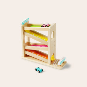 Tiny Land® Montessori Toys for Toddlers (16–18 Months) by Tiny Land features a wooden car ramp with four colorful tracks and three small cars, ideal for early learning. One blue car is at the base, two others rest on upper tracks against a plain background.