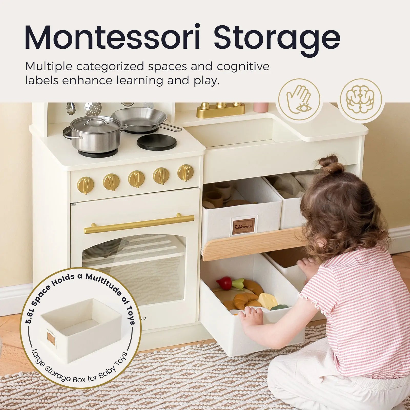 A toddler sorts play food into bins in the Tiny Land® Wooden Play Kitchen with Storage by Tiny Land. Montessori storage features cognitive labels and compartments for organizing pretend cookware and toys, promoting creative play|cream