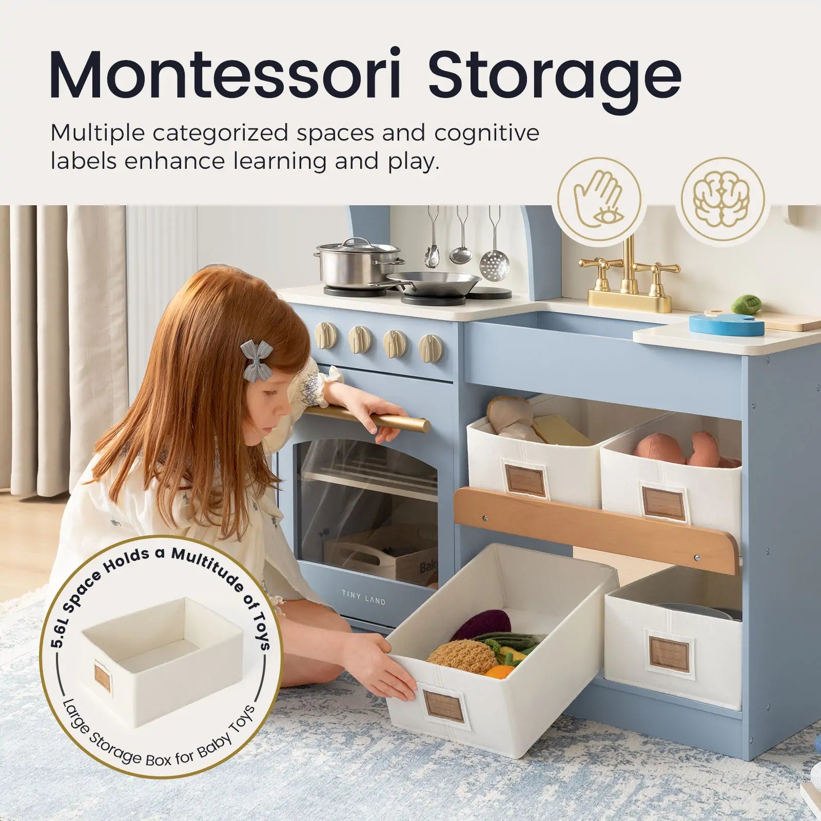 A young girl with a headband sorts toys into labeled bins on a blue and white storage unit, while the Tiny Land® Pretend Play Kitchen for Kids – Serenity Wooden Kitchen (Blue) offers playtime fun in the background. A circular label highlights the storage box|blue